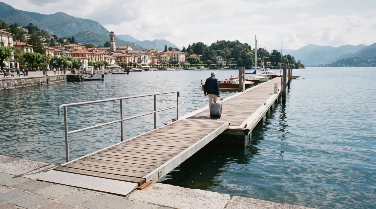 A boarding gangway laid from a landing stage onto a lake ship on a calm morning, the moment that decides Lake Como accessibility