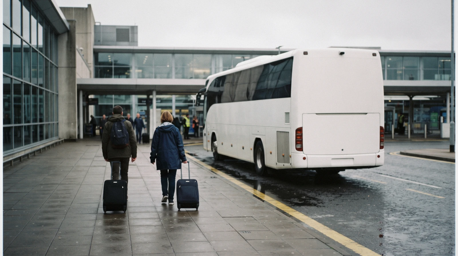 A coach waiting at an airport arrivals bay with luggage being loaded, the transfer from Malpensa to Lake Como