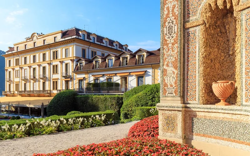 The lakeside facade and gardens of Villa d'Este, a Lake Como hotel in Cernobbio