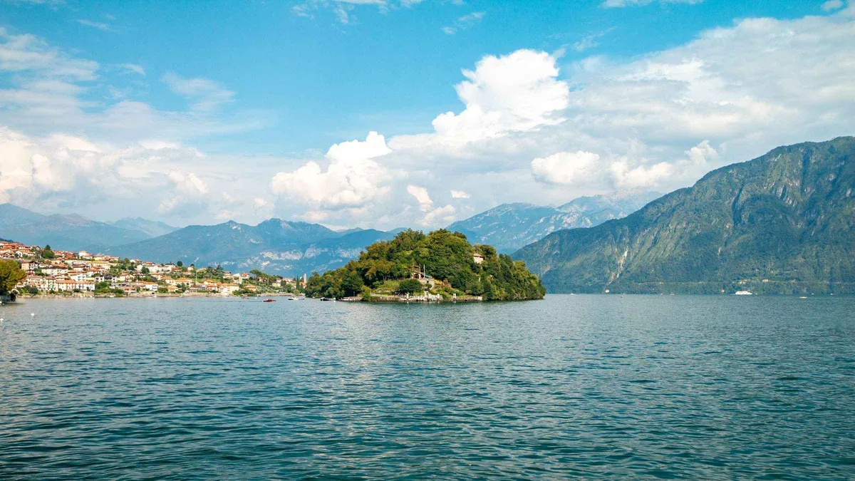 Shared cruise boat passing the gardens of Villa Carlotta at Tremezzo on Lake Como