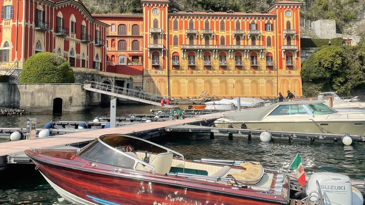 Classic wooden boat with sunshade on a private boat tour of Lake Como near Torno