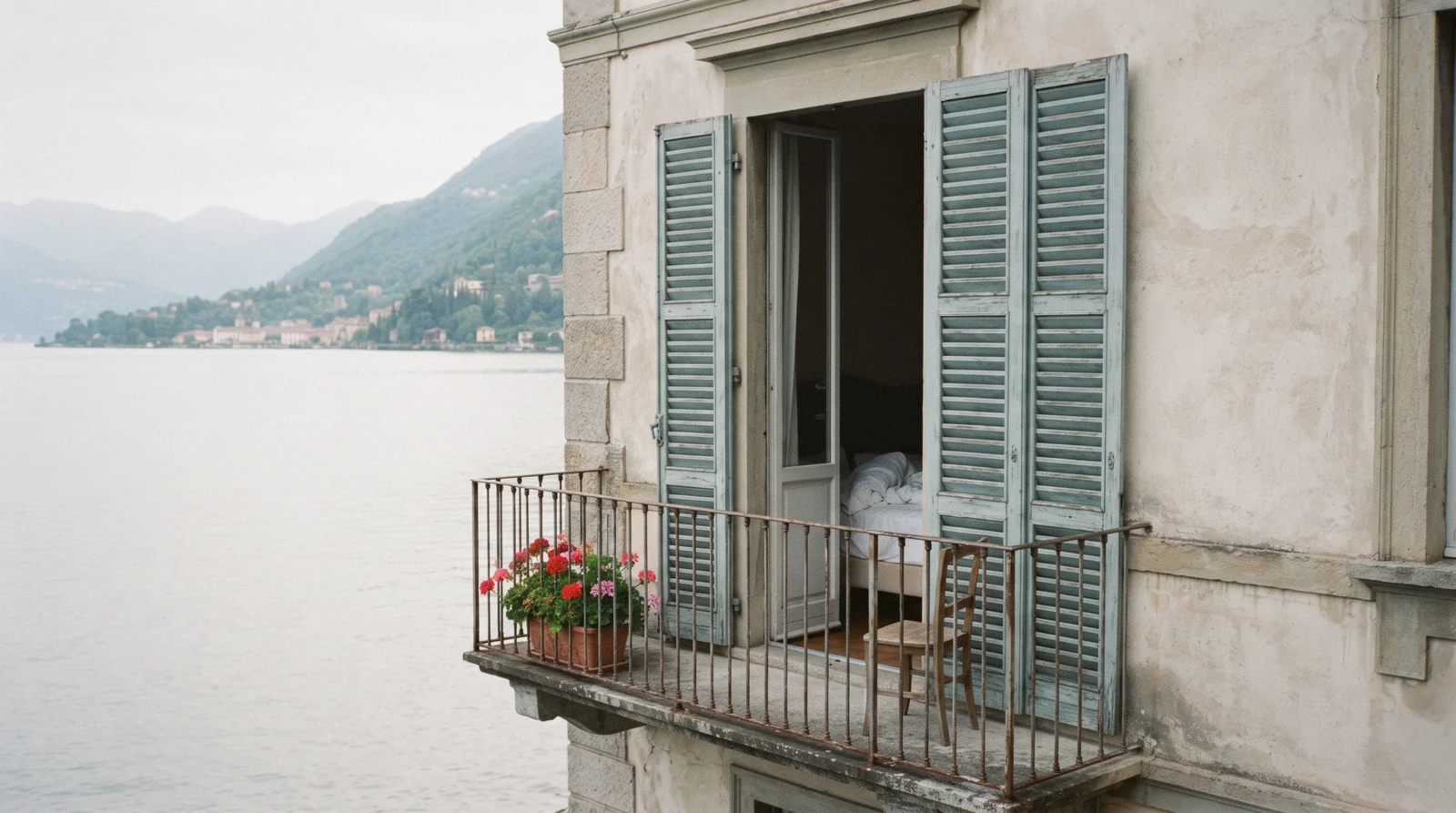 Pastel houses stacked above a small harbour at first light, the kind of village to choose when deciding where to stay in Lake Como